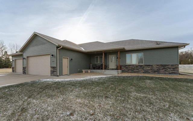 view of front of property with a front yard and a garage