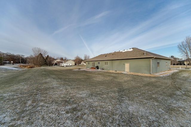 view of side of home with a lawn