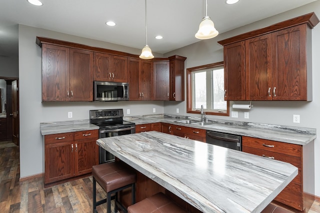 2155 Maple Leaf Ln NE, Owatonna, MN 55060 - kitchen with stainless steel microwave, black range with electric stovetop, dishwashing machine, wood finished floors, and a kitchen breakfast bar