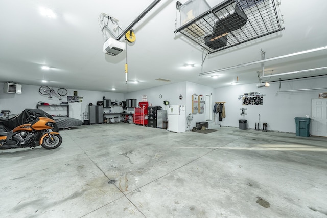 2155 Maple Leaf Ln NE, Owatonna, MN 55060 - garage with a garage door opener and freestanding refrigerator