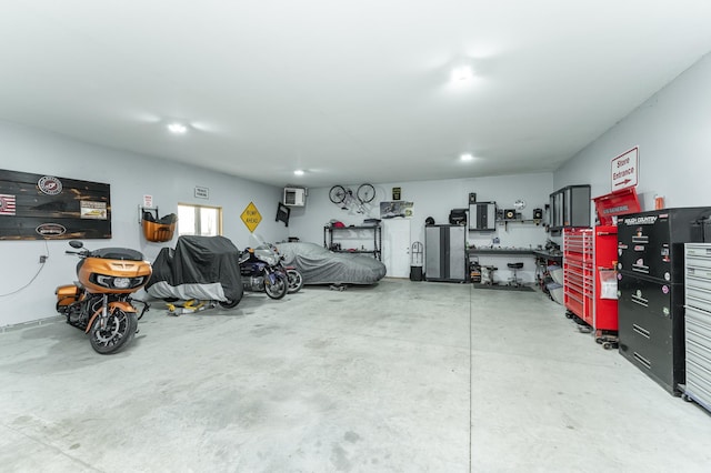 2155 Maple Leaf Ln NE, Owatonna, MN 55060 - garage featuring a wall unit AC