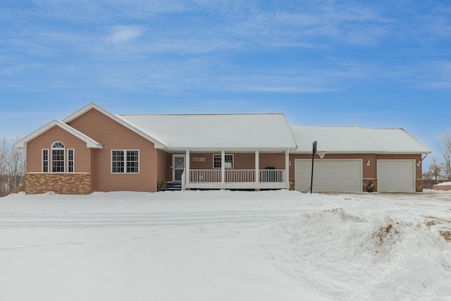 view of front facade featuring a garage, a porch, and brick siding