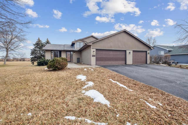 view of front of property with a garage and a front lawn