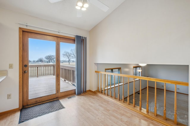 entryway with ceiling fan, hardwood / wood-style floors, and lofted ceiling