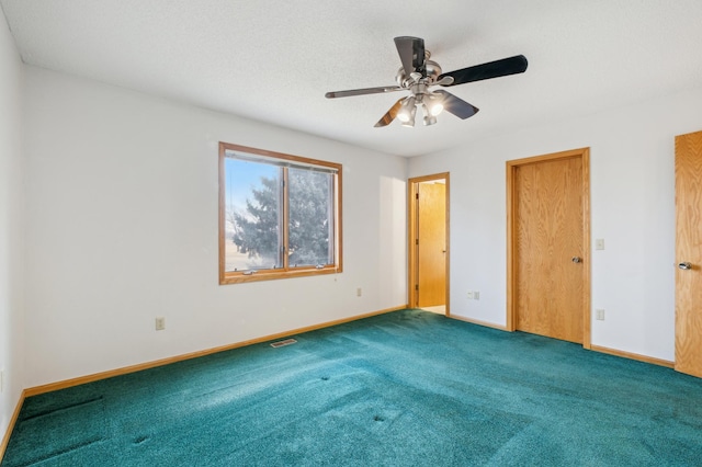 unfurnished bedroom featuring ceiling fan and carpet