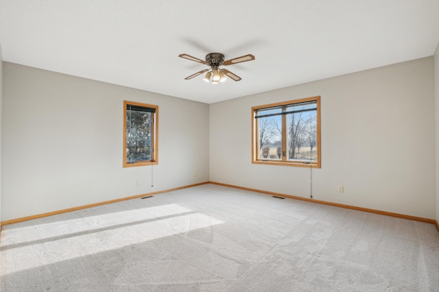 carpeted empty room featuring ceiling fan