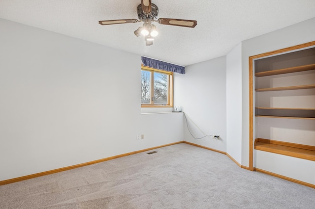 unfurnished bedroom featuring a textured ceiling, carpet floors, a closet, and ceiling fan