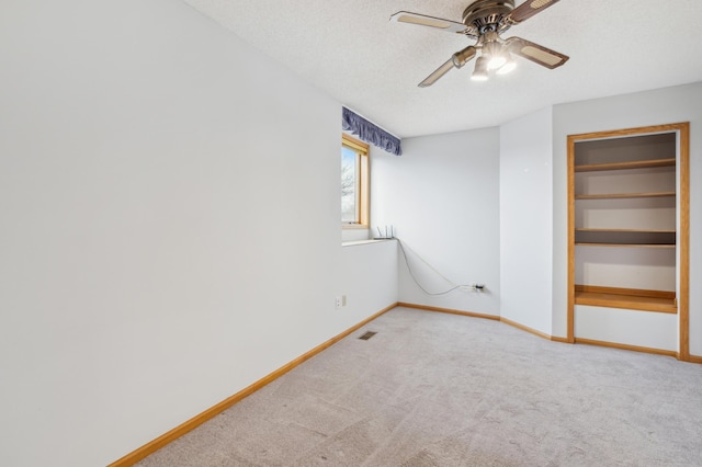 interior space featuring carpet flooring, ceiling fan, a closet, and a textured ceiling