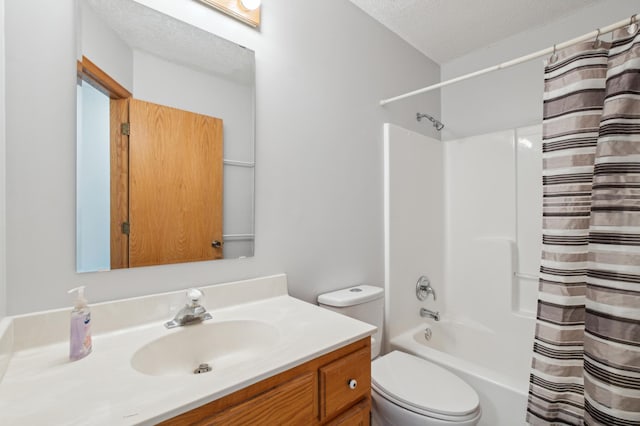 full bathroom featuring vanity, toilet, shower / bath combo with shower curtain, and a textured ceiling