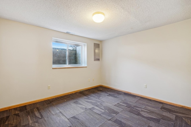 carpeted spare room featuring a textured ceiling