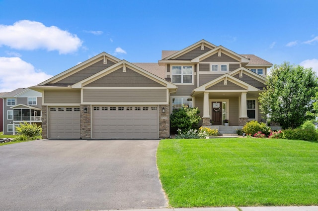 craftsman-style house featuring a front yard and a garage