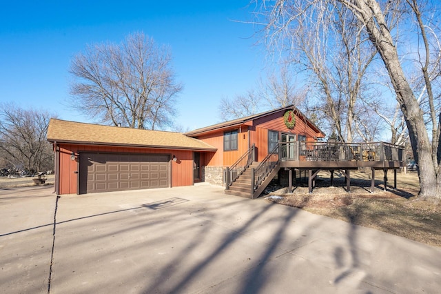 view of front of home with a garage and a deck