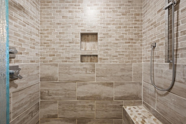 bathroom featuring tiled shower