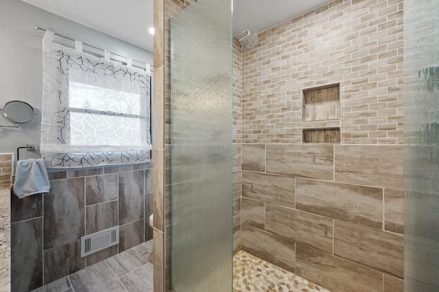 bathroom with a tile shower