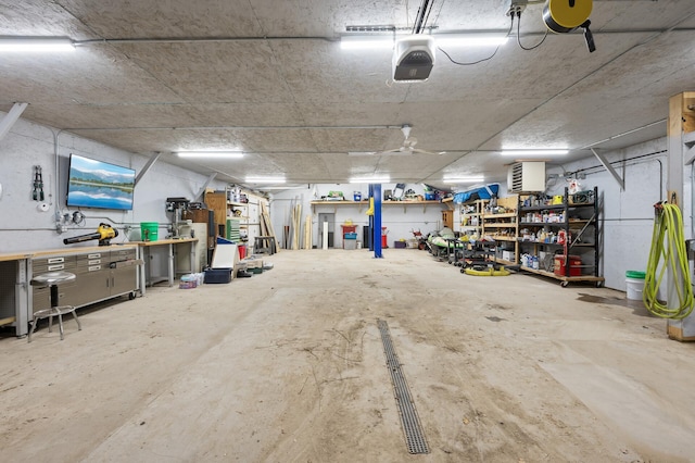 garage with a workshop area and a garage door opener