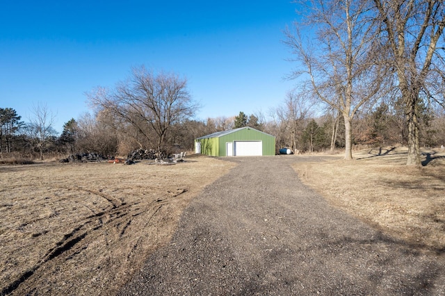 exterior space featuring a garage and an outbuilding