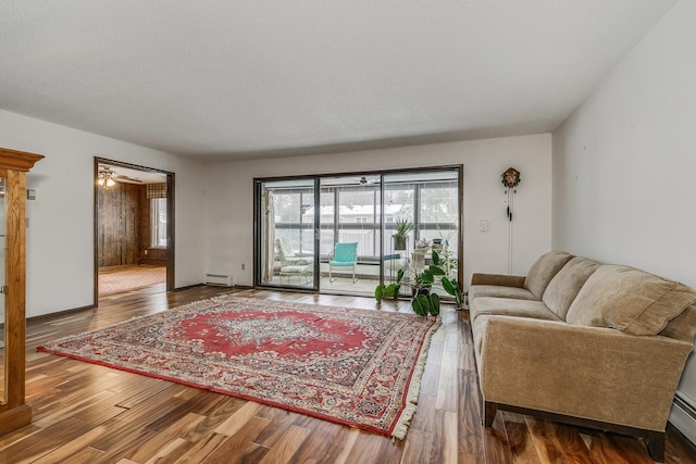 living area with a baseboard radiator and wood finished floors