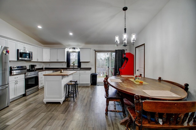 kitchen with a center island, white cabinets, and stainless steel appliances