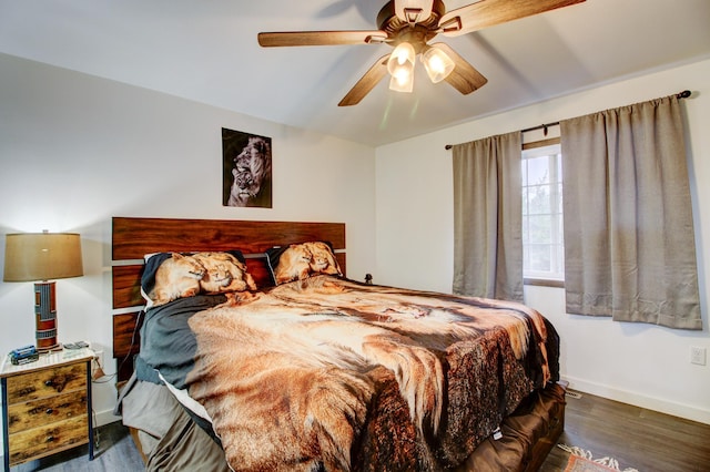 bedroom featuring ceiling fan and dark hardwood / wood-style floors