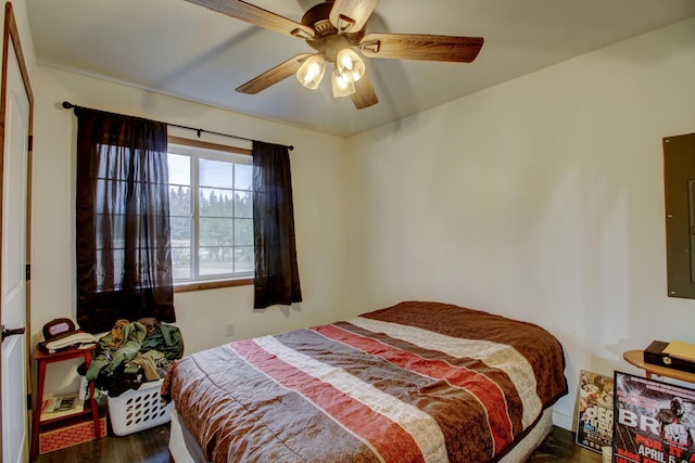 bedroom featuring ceiling fan and dark wood-type flooring