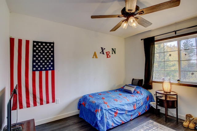 bedroom with ceiling fan and dark wood-type flooring