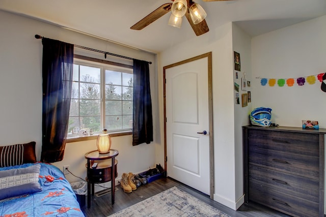 bedroom featuring ceiling fan and dark wood-type flooring