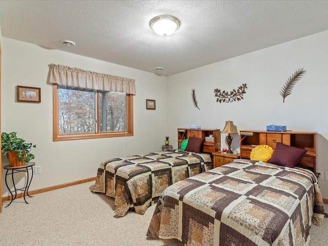 bedroom with carpet and a textured ceiling