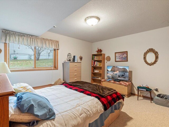 carpeted bedroom with a textured ceiling