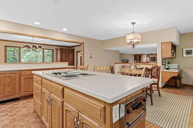 6678 Hemlock Ln N, Maple Grove, MN 55369 - kitchen featuring a chandelier, a kitchen island, light countertops, hanging light fixtures, and recessed lighting