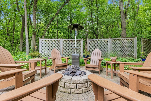 6678 Hemlock Ln N, Maple Grove, MN 55369 - view of patio with an outdoor fire pit and view of scattered trees
