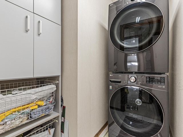 6678 Hemlock Ln N, Maple Grove, MN 55369 - laundry room featuring estacked washer and dryer, cabinet space, and baseboards