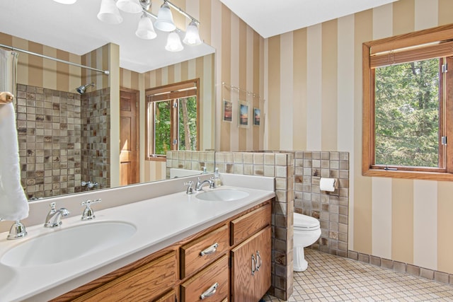 6678 Hemlock Ln N, Maple Grove, MN 55369 - full bathroom with wallpapered walls, toilet, double vanity, plenty of natural light, and a tile shower