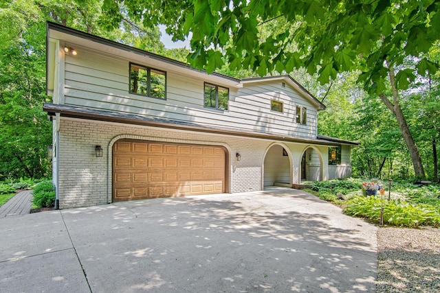 6678 Hemlock Ln N, Maple Grove, MN 55369 - view of front of property featuring brick siding, a garage, and asphalt driveway