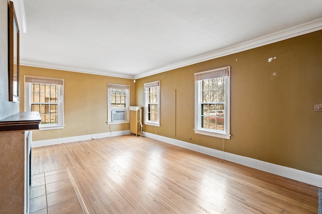 unfurnished living room with crown molding and light hardwood / wood-style flooring