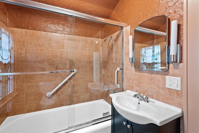 bathroom with vanity and bath / shower combo with glass door