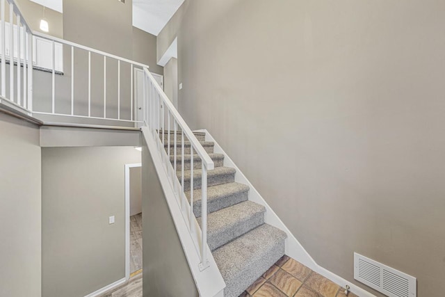 stairs featuring a high ceiling