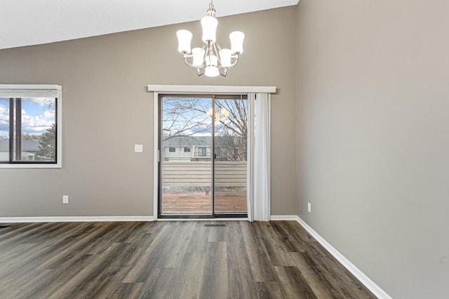 unfurnished dining area featuring dark hardwood / wood-style flooring, lofted ceiling, and a wealth of natural light