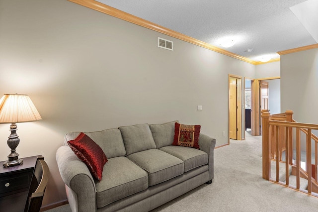 living area with visible vents, ornamental molding, baseboards, light colored carpet, and a textured ceiling