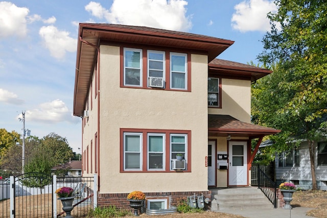 3532 Longfellow Ave, Minneapolis, MN 55407 - view of front facade with stucco siding, fence, a gate, a shingled roof, and cooling unit