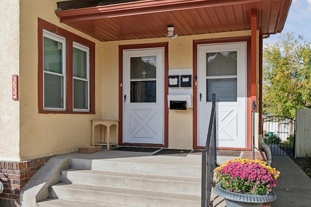 3532 Longfellow Ave, Minneapolis, MN 55407 - view of exterior entry with stucco siding, covered porch, and a gate
