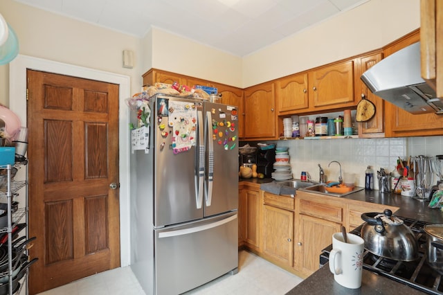 3532 Longfellow Ave, Minneapolis, MN 55407 - kitchen featuring freestanding refrigerator, a sink, brown cabinetry, dark countertops, and backsplash
