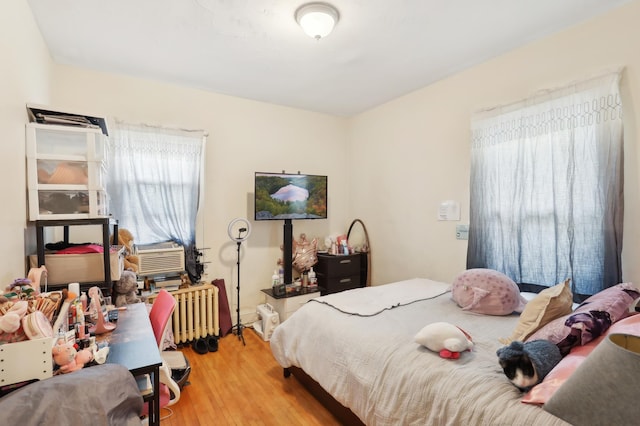 3532 Longfellow Ave, Minneapolis, MN 55407 - bedroom featuring wood finished floors and radiator