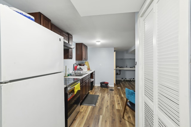 3532 Longfellow Ave, Minneapolis, MN 55407 - kitchen with freestanding refrigerator, stainless steel electric range, light wood-style floors, under cabinet range hood, and a sink