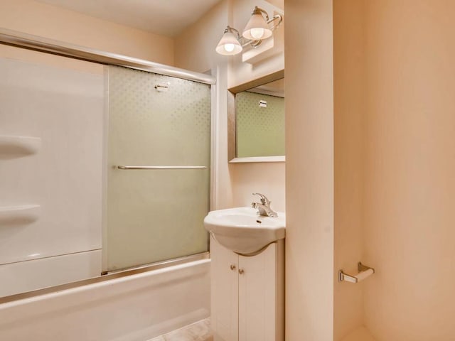 bathroom featuring shower / bath combination with glass door and sink