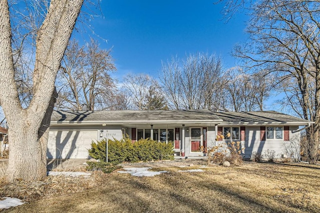 ranch-style house with a garage and a front lawn