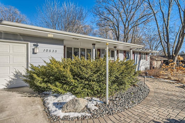 doorway to property with a garage