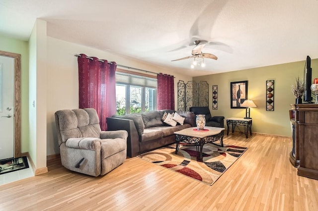 living room featuring light hardwood / wood-style floors and ceiling fan