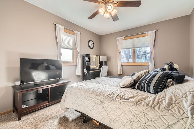 carpeted bedroom with ceiling fan and multiple windows