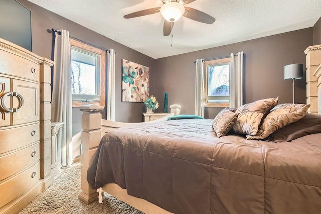 bedroom featuring multiple windows, light carpet, and ceiling fan