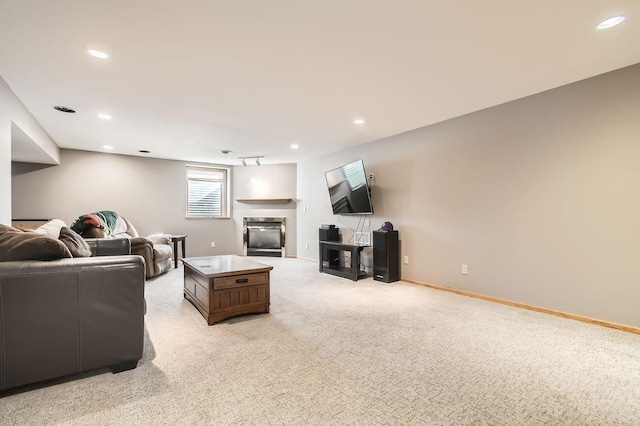 carpeted living room featuring a tile fireplace